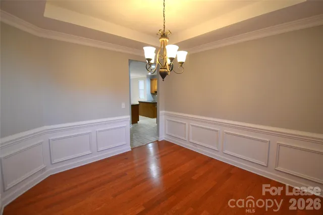 a view of a room with wooden floor and white walls