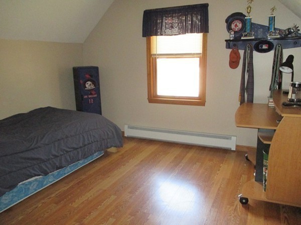 144 Shadow Lake Road Salem, NH 03079 - Photo 16 of 19 a bedroom with a bed and wooden floor