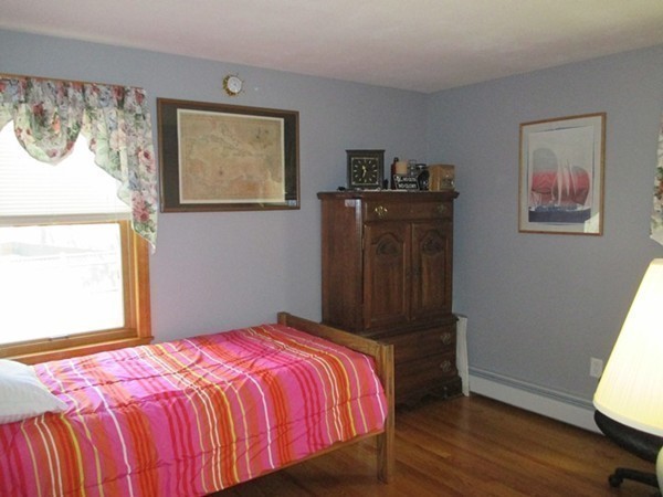 144 Shadow Lake Road Salem, NH 03079 - Photo 17 of 19 a bedroom with a bed and wooden floor