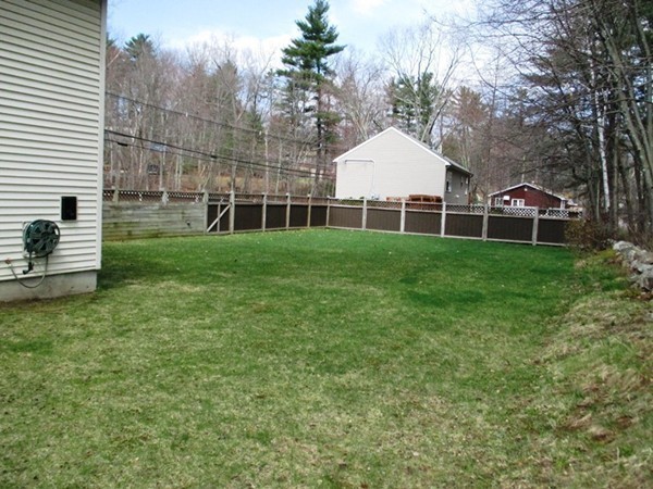 144 Shadow Lake Road Salem, NH 03079 - Photo 19 of 19 a view of a white house next to a yard with big trees