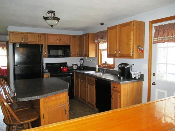 144 Shadow Lake Road Salem, NH 03079 - Photo 2 of 19 a kitchen with stainless steel appliances granite countertop a sink stove and refrigerator