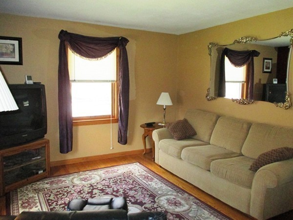 144 Shadow Lake Road Salem, NH 03079 - Photo 8 of 19 a living room with a couch and a flat screen tv