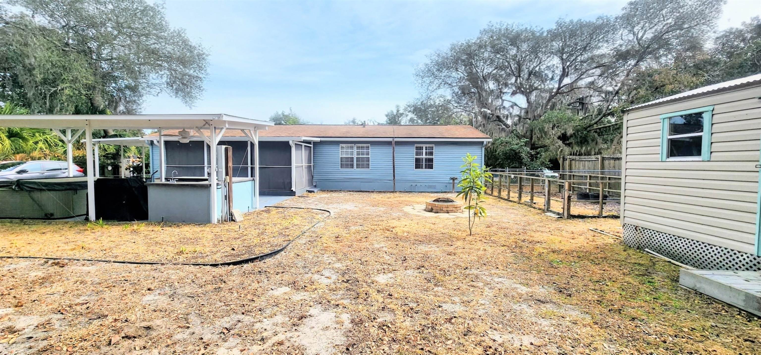 3969 Oak Terrace Road St. Augustine, FL 32086 - Photo 28 of 29 Rear view of house featuring an outdoor fire pit and a sunroom