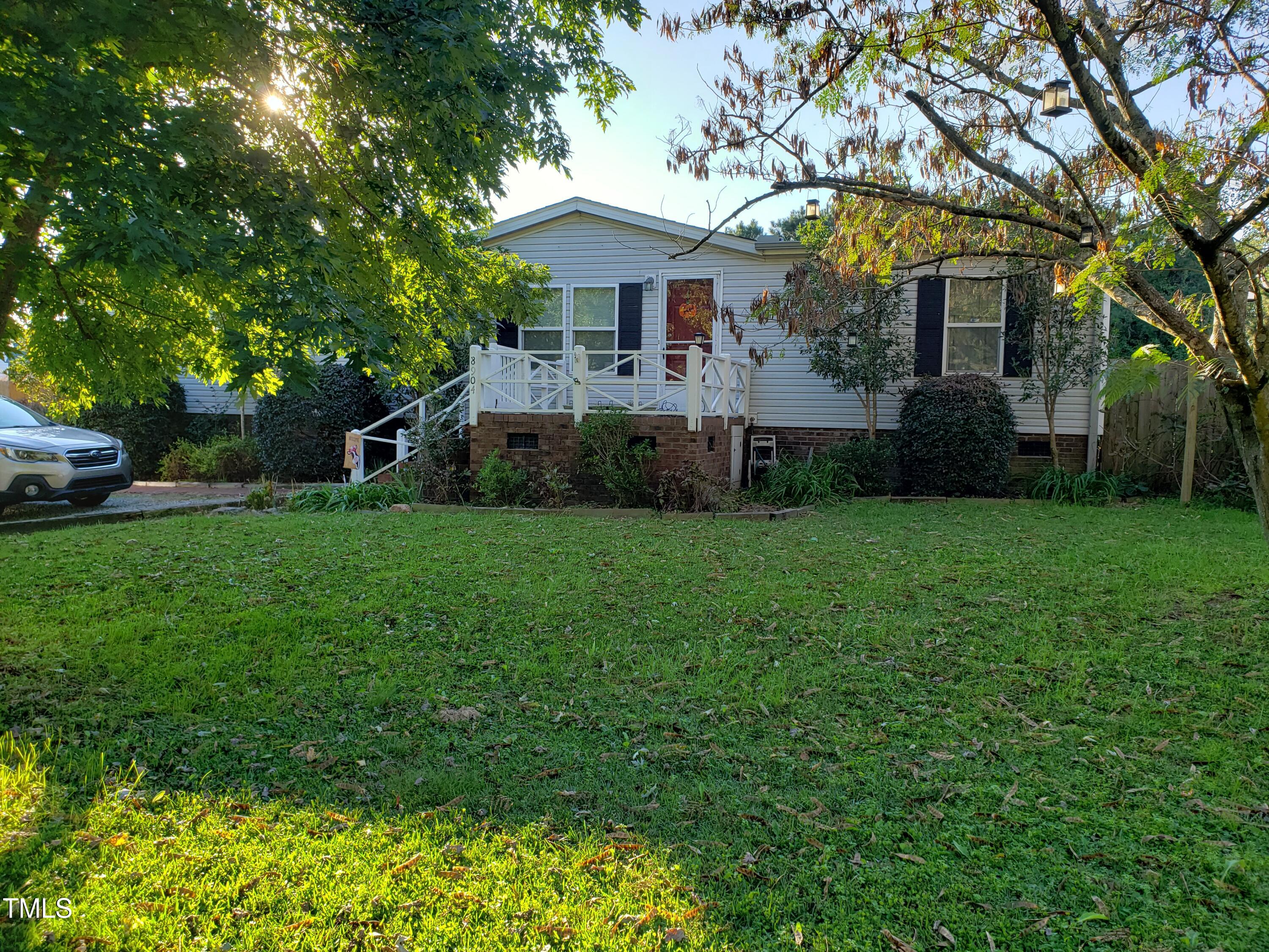 8904 Kennebec Road Willow Spring, NC 27592 - Photo 1 of 42 a front view of house with yard and green space