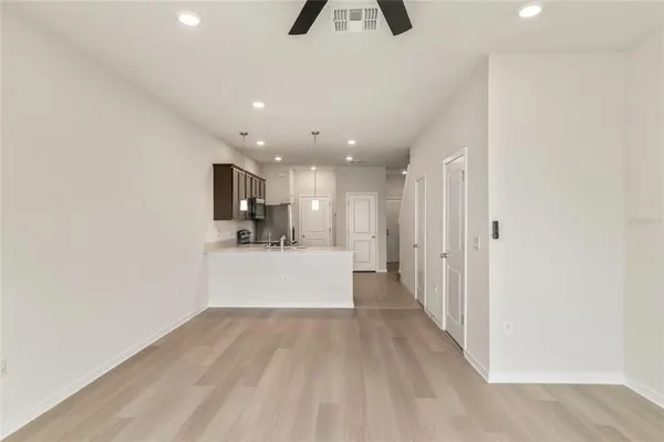 a view of kitchen and hall with wooden floor