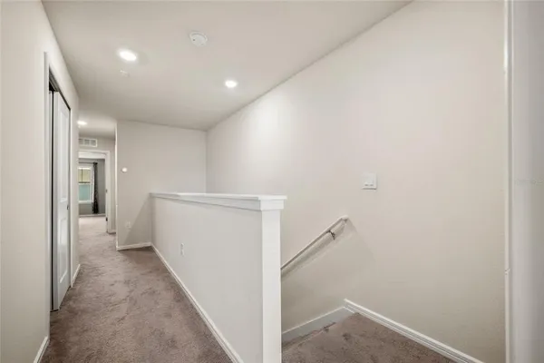 a view of a hallway with a white walls