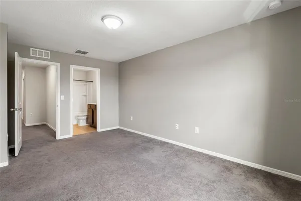 an empty room with closet area