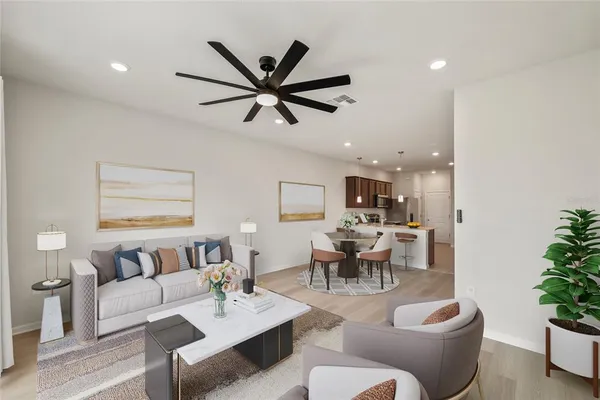 a living room with furniture and a potted plant