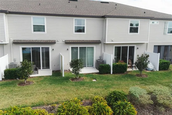 a view of a house with backyard and porch