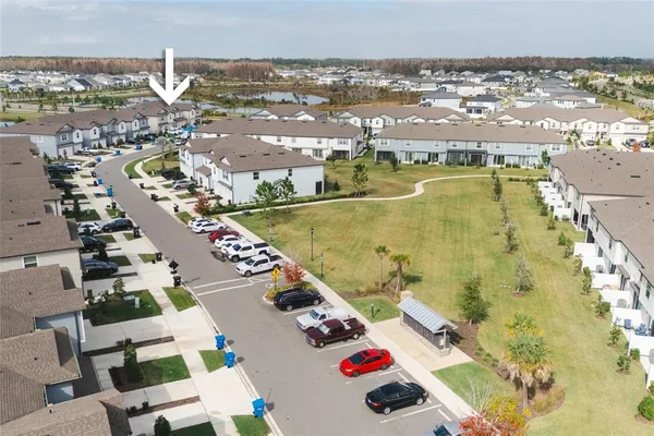 an aerial view of residential houses with outdoor space