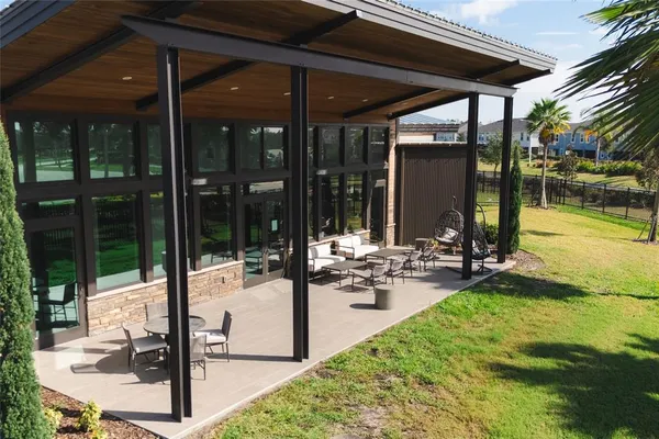 a view of a swimming pool with chairs in patio
