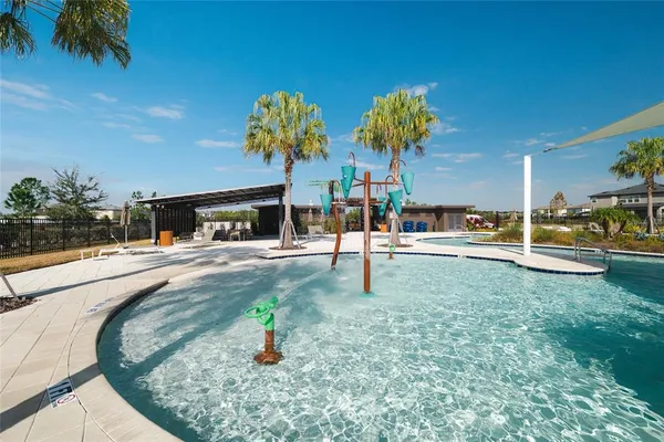 a swimming pool with lots of tress in front of it