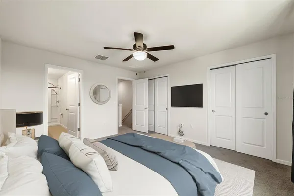 a bedroom with a bed and a flat screen tv