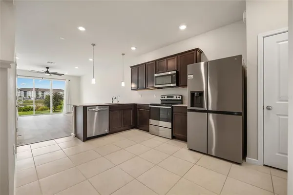 a kitchen with stainless steel appliances a refrigerator and a stove top oven