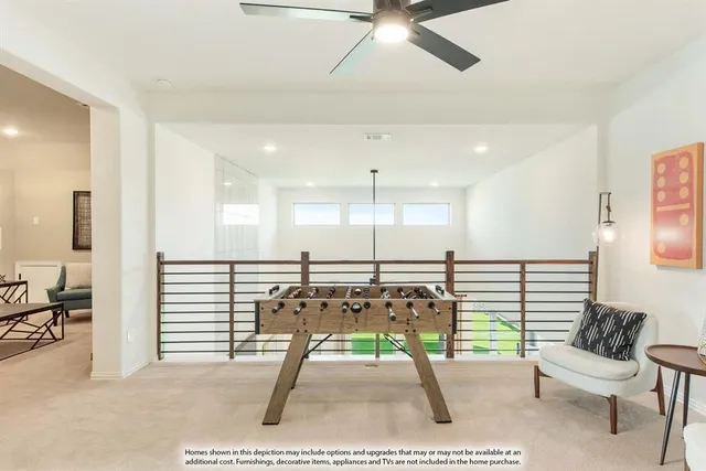 a living room with furniture a rug and white walls