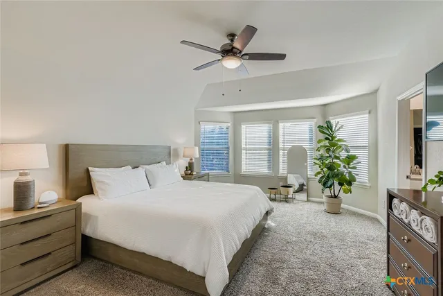 a bedroom with a bed and a potted plant