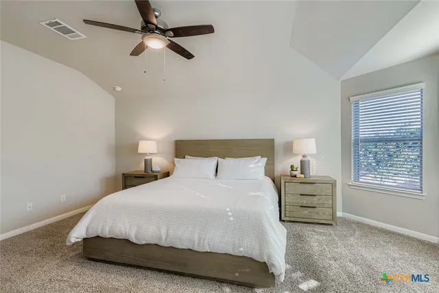 a bedroom with a bed dresser and a window