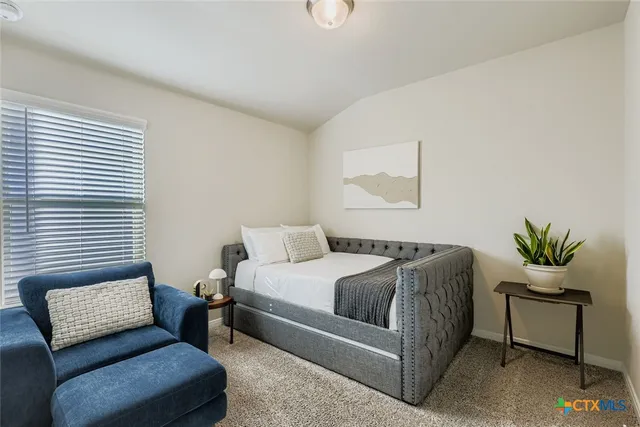 a bedroom with a bed and couch