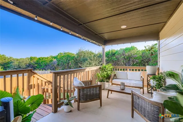 a view of a patio with couches chairs and a potted plant