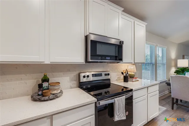a kitchen with a sink stove and microwave