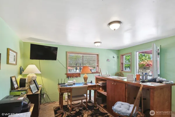 a bedroom with a bed chair and a lamp on a dresser