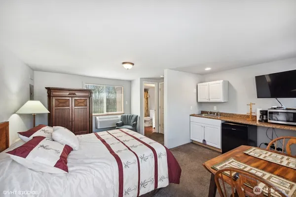 a bedroom with bed and a couch