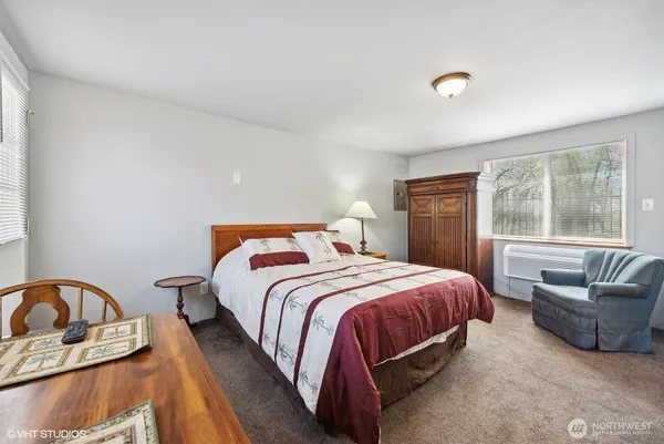 a bedroom with a bed and a couch