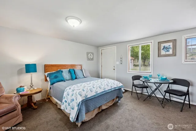 a bedroom with a bed and a couch