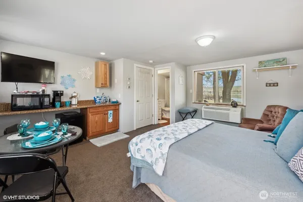 a bedroom with a bed and a couch