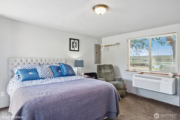 a bedroom with a bed and a window