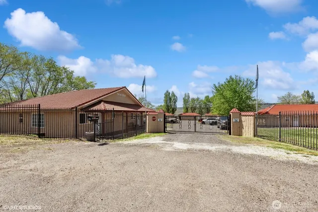 a view of a house with backyard and fence