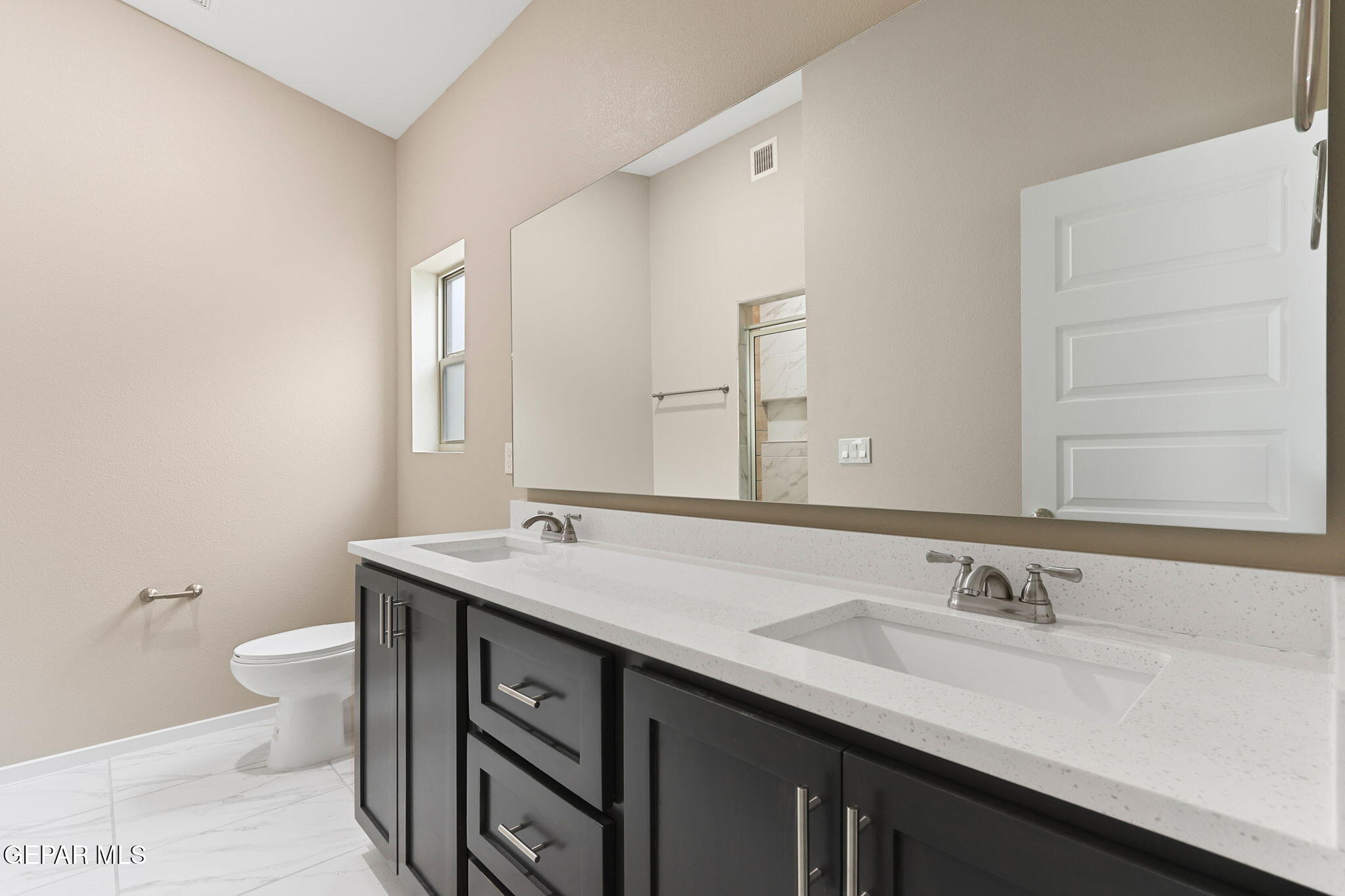 609 Espa Court Vinton, TX 79821 - Photo 13 of 19 a bathroom with a granite countertop sink and a mirror