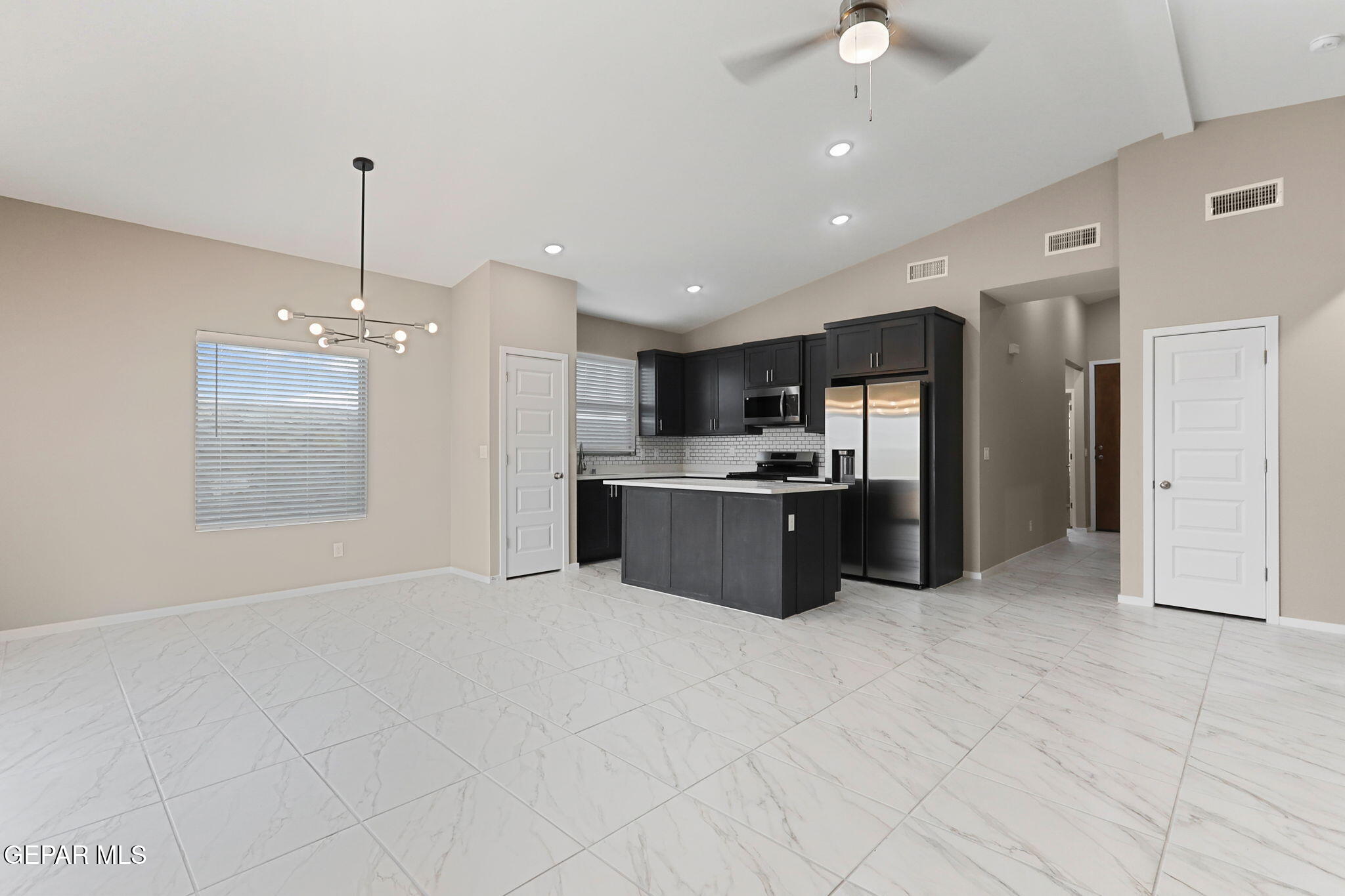 609 Espa Court Vinton, TX 79821 - Photo 4 of 19 a large kitchen with kitchen island a sink stainless steel appliances and cabinets