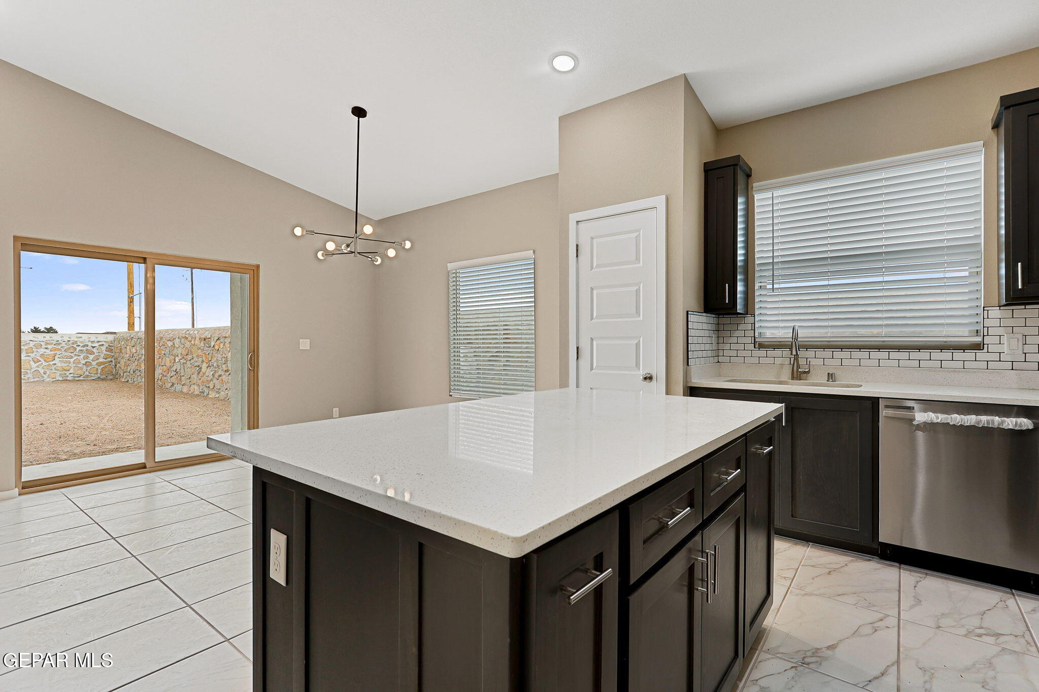 609 Espa Court Vinton, TX 79821 - Photo 6 of 19 a kitchen with a stove a refrigerator a sink and dishwasher with wooden floor