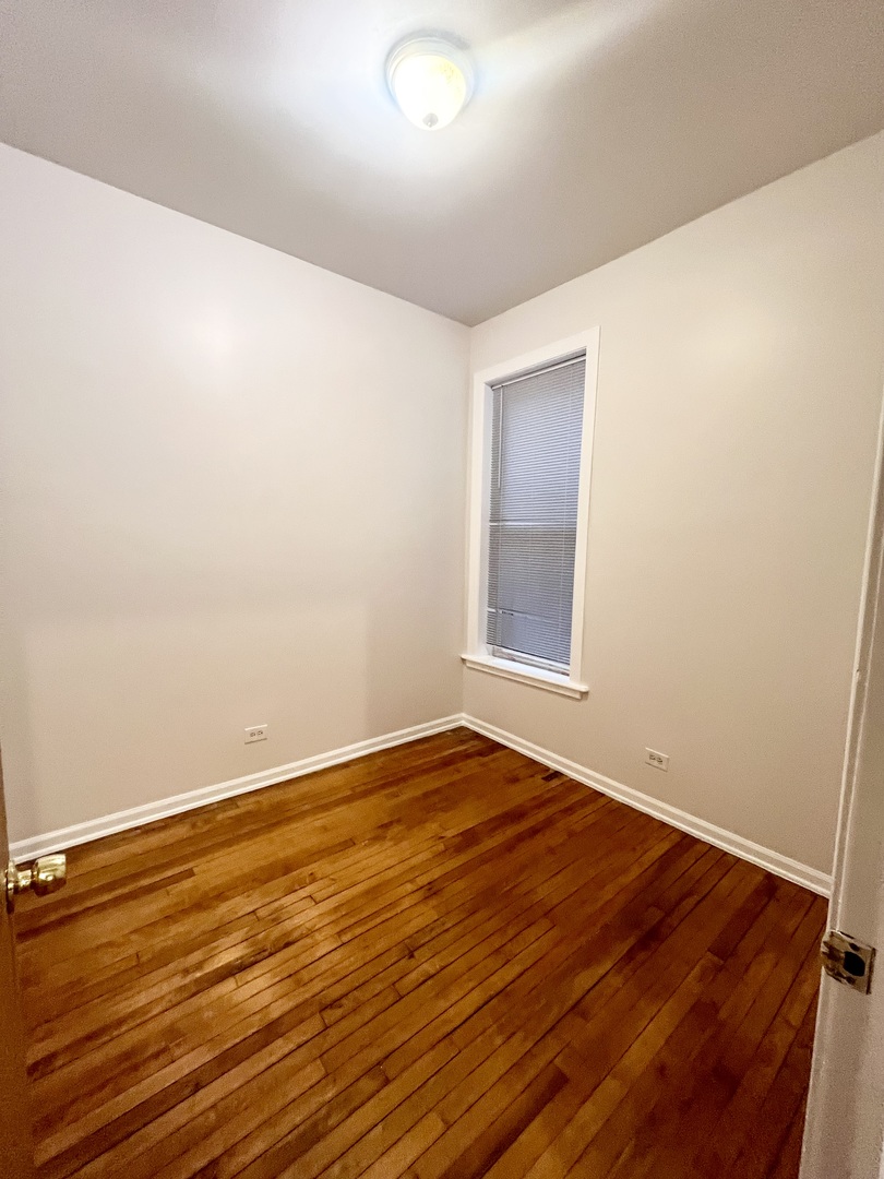 3227 South Carpenter Street, Unit 1M Chicago, IL 60608 - Photo 12 of 14 a view of an empty room with wooden floor