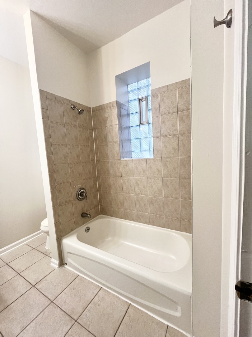 3227 South Carpenter Street, Unit 1M Chicago, IL 60608 - Photo 5 of 14 a bathroom with a bathtub and shower