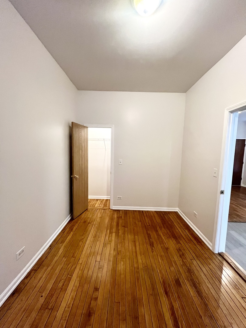 3227 South Carpenter Street, Unit 1M Chicago, IL 60608 - Photo 9 of 14 a view of an empty room with wooden floor