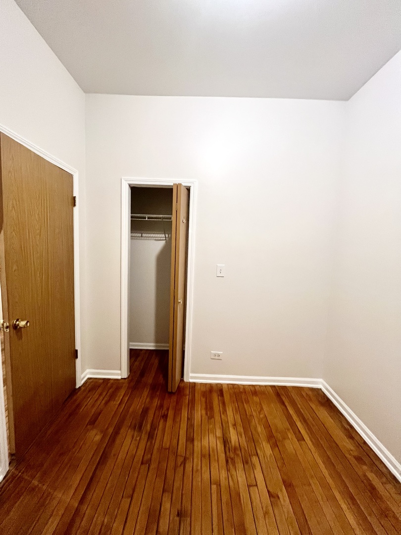 3227 South Carpenter Street, Unit 1M Chicago, IL 60608 - Photo 10 of 14 a view of a room with wooden floor