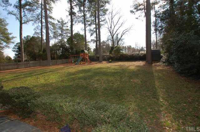 3427 Redbud Lane Raleigh, NC 27607 - Photo 5 of 12 Home has a huge fenced in back yard with stamped concrete patio. Storage shed conveys. Other