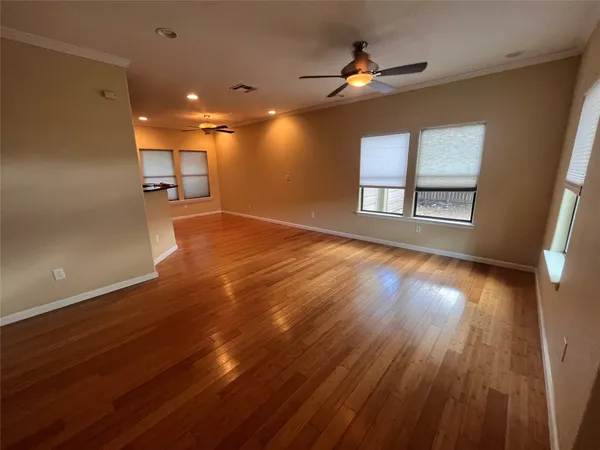 a view of a room with wooden floor