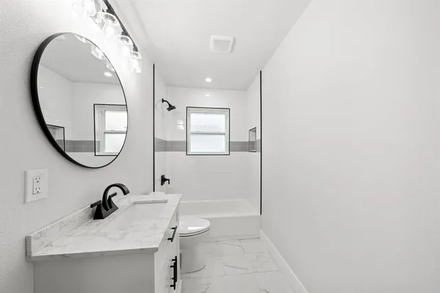 a bathroom with a sink a mirror and a toilet