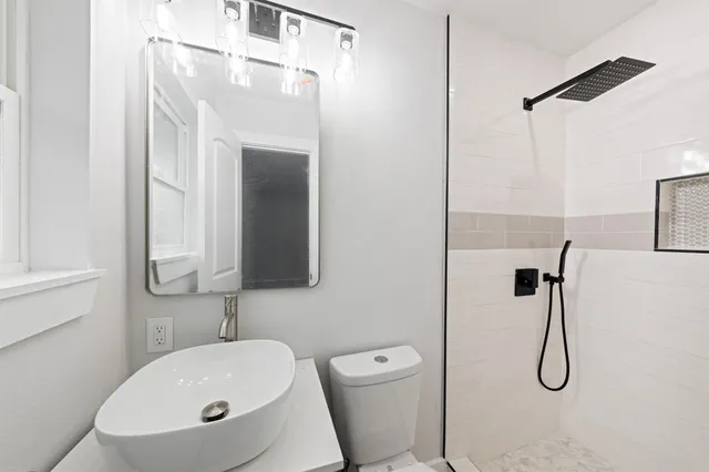 a bathroom with a sink toilet and shower