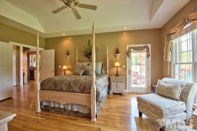 8306 Ball Road Bahama, NC 27503 - Photo 11 of 21 Large Master Bedroom with hardwood floors and access to the deck.