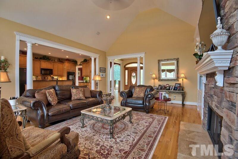 8306 Ball Road Bahama, NC 27503 - Photo 3 of 21 Family Room with built-ins, stacked stone fireplace, hardwood floor, French doors to deck.