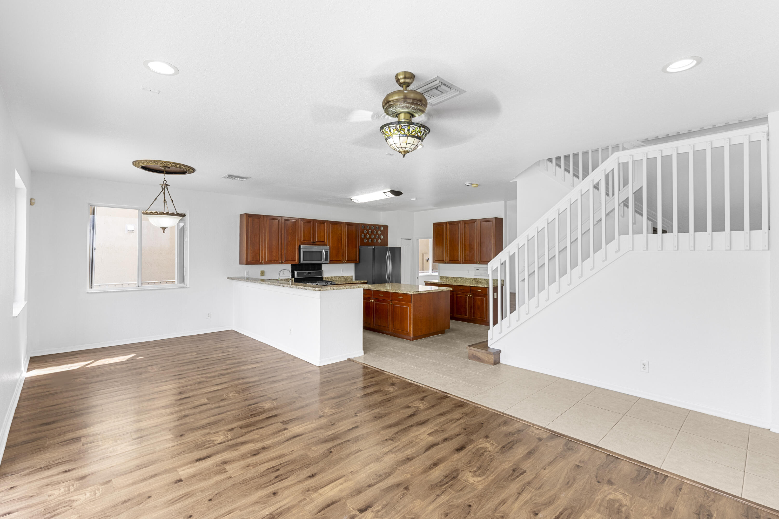 19389 Southwest 64th Street Pembroke Pines, FL 33332 - Photo 11 of 61 a view of a kitchen with kitchen island wooden floor appliances and a window