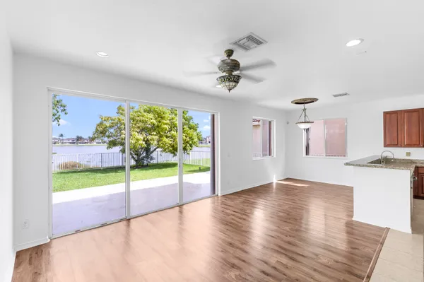 an empty room with a window and a ceiling fan