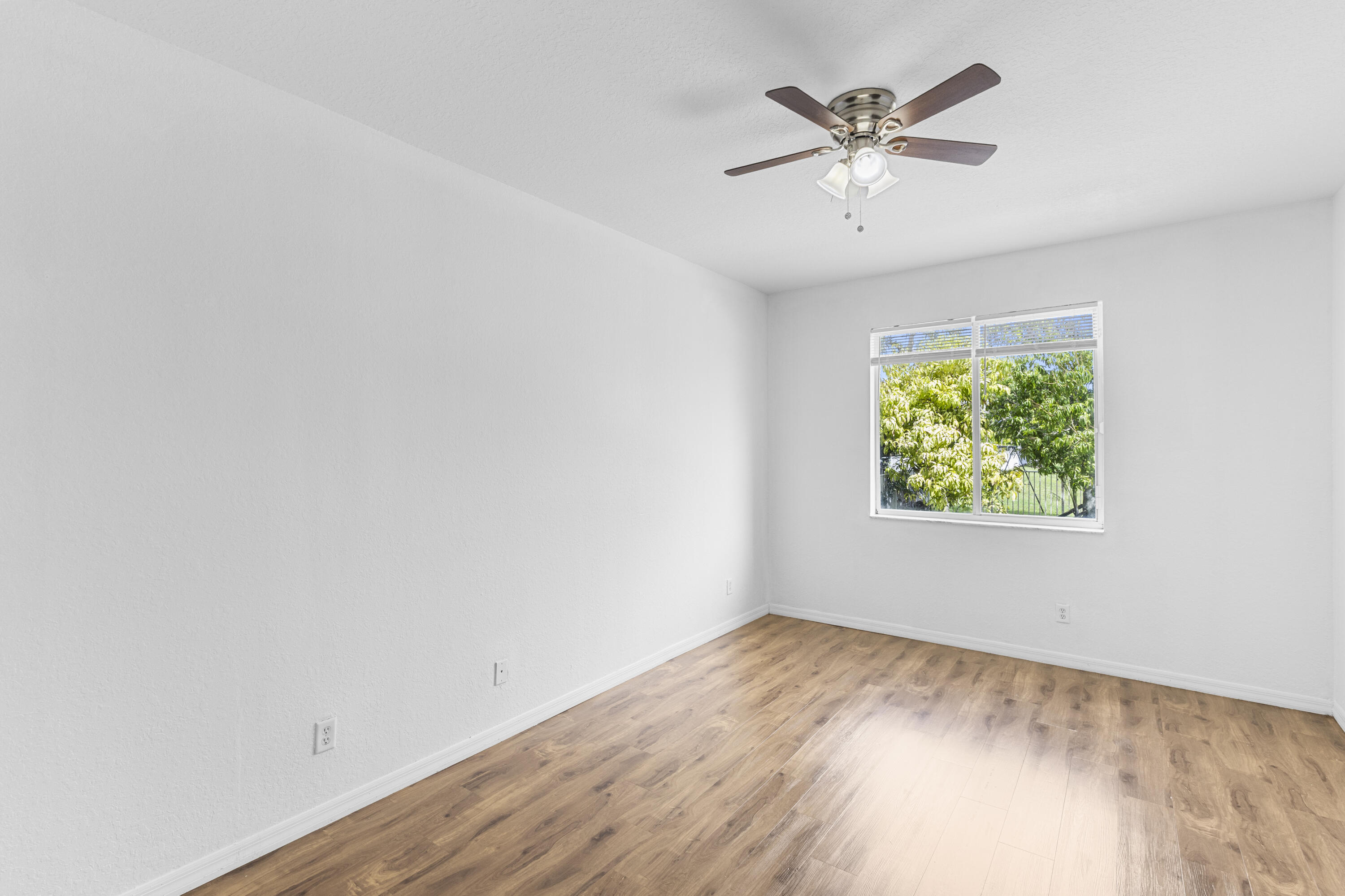19389 Southwest 64th Street Pembroke Pines, FL 33332 - Photo 14 of 61 an empty room with a window and a ceiling fan