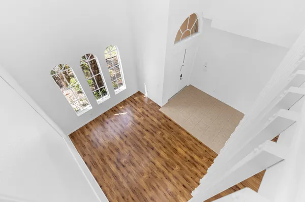a view of a room with wooden floor