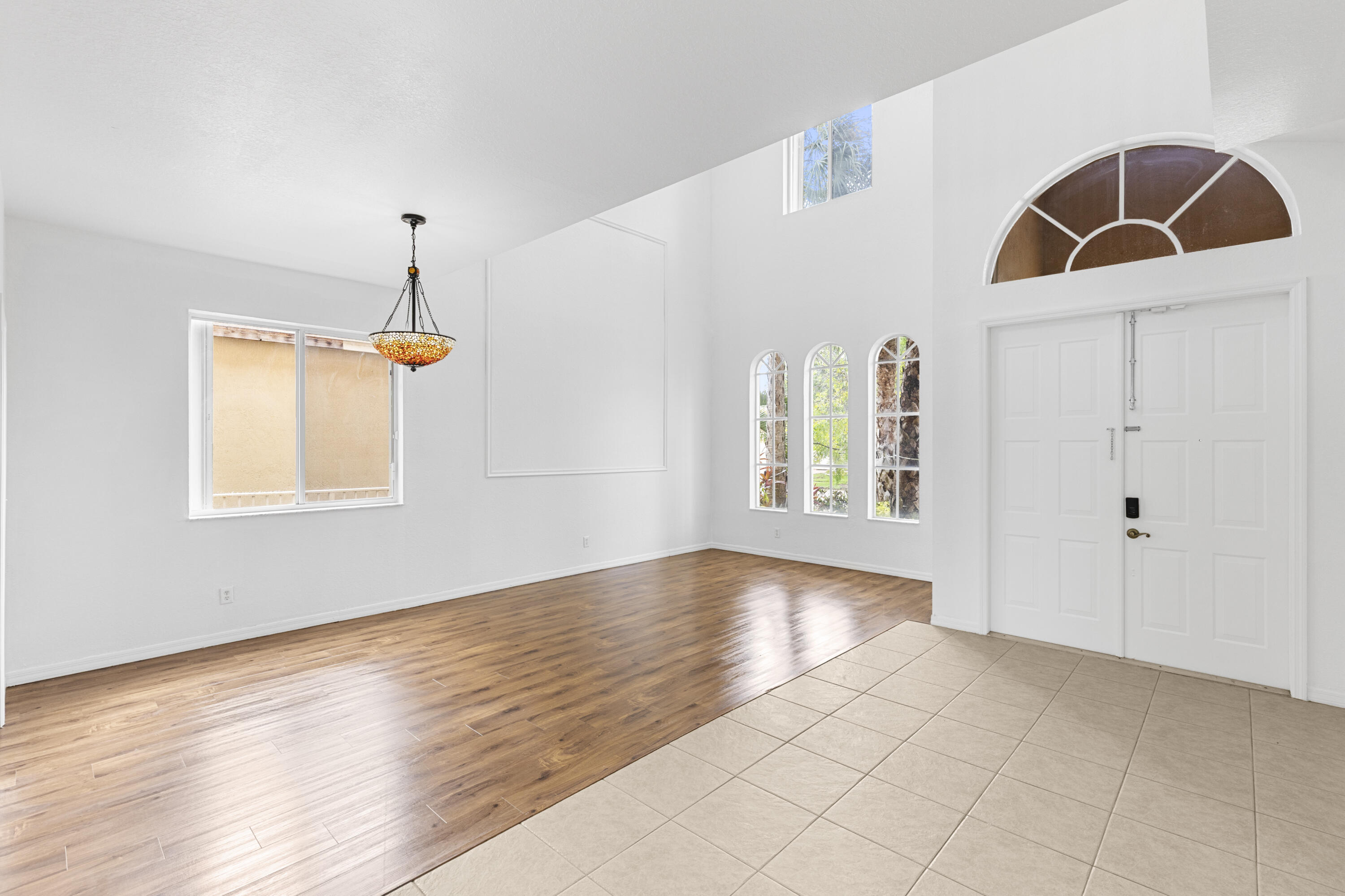 19389 Southwest 64th Street Pembroke Pines, FL 33332 - Photo 2 of 61 a view of an empty room with window and wooden floor
