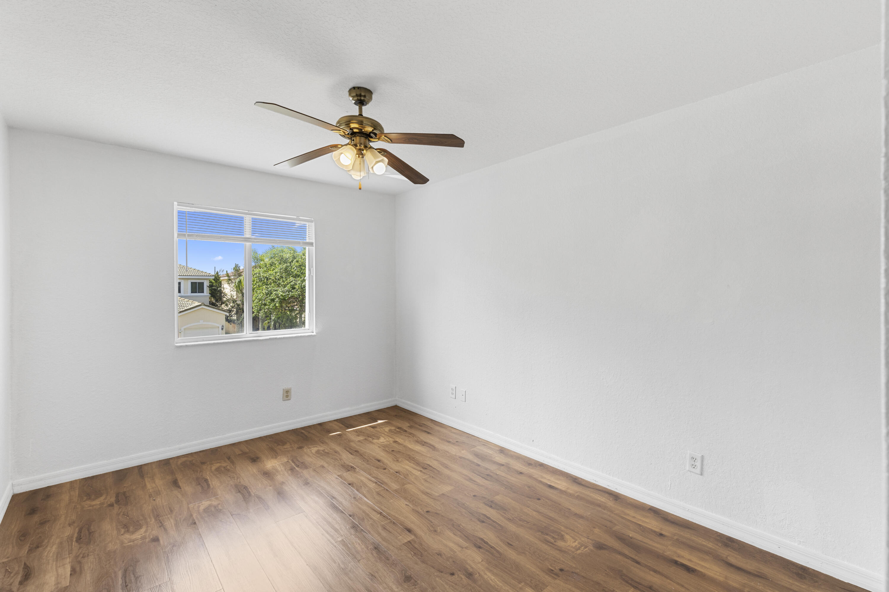 19389 Southwest 64th Street Pembroke Pines, FL 33332 - Photo 21 of 61 a view of empty room with wooden floor and fan